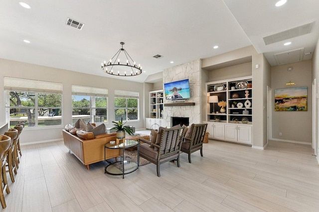 living room with baseboards, light wood-style flooring, visible vents, and a stone fireplace