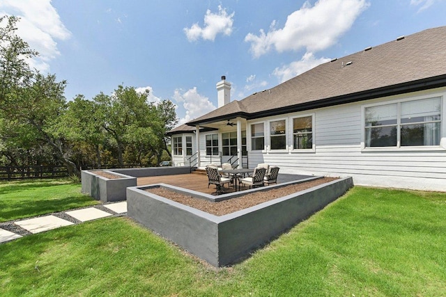 back of house with ceiling fan, a chimney, a lawn, fence, and a patio