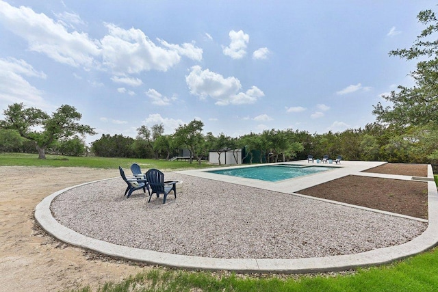 outdoor pool with a lawn and a patio area