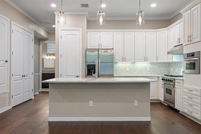 kitchen with light countertops, white cabinetry, appliances with stainless steel finishes, and backsplash