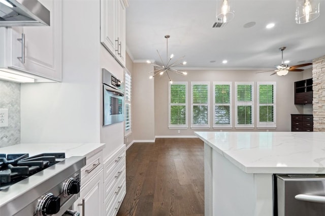 kitchen featuring visible vents, ornamental molding, white cabinetry, and a healthy amount of sunlight