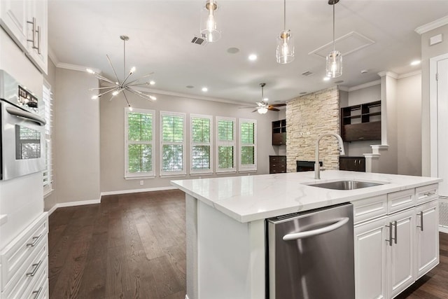 kitchen featuring a sink, ornamental molding, open floor plan, and stainless steel appliances