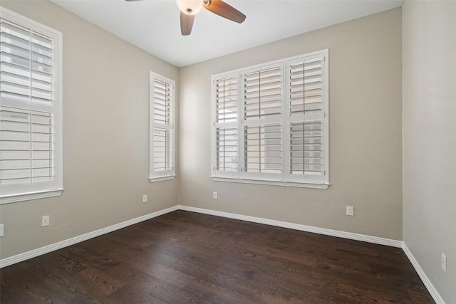 unfurnished room featuring baseboards, ceiling fan, wood finished floors, and a wealth of natural light