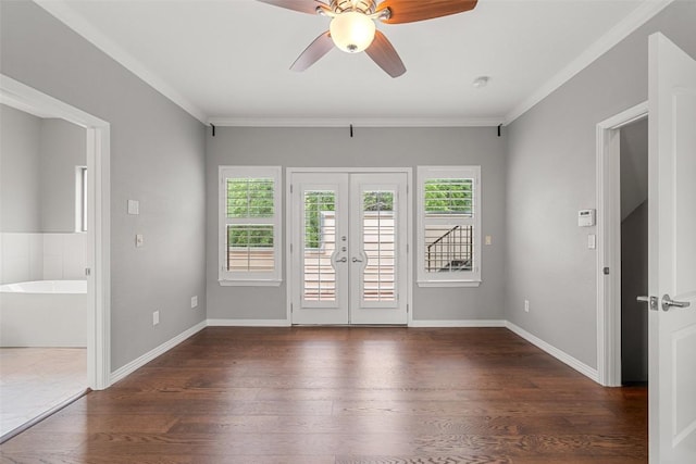 spare room with crown molding, a ceiling fan, french doors, and wood finished floors