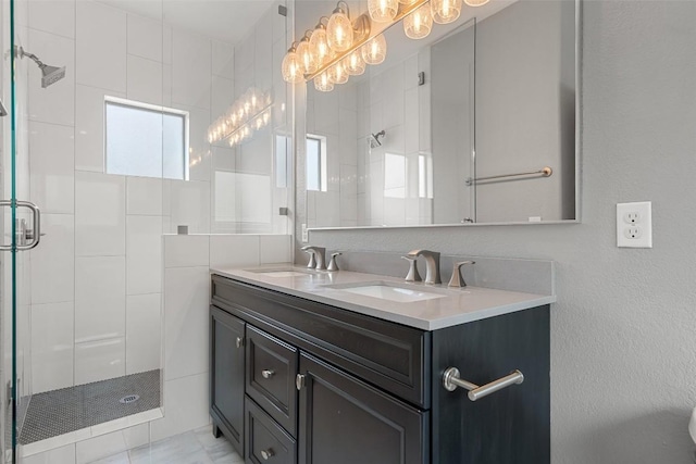 full bath with double vanity, a sink, and a shower stall