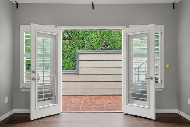 doorway to outside with baseboards, french doors, and wood finished floors