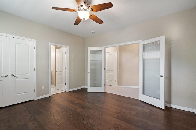 unfurnished bedroom with baseboards, french doors, and wood finished floors