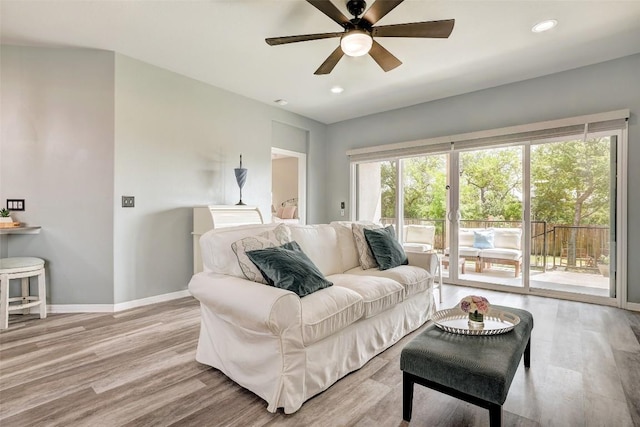 living area with a ceiling fan, baseboards, recessed lighting, and light wood finished floors