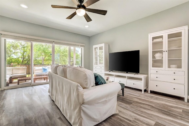 living room with recessed lighting, ceiling fan, and light wood finished floors