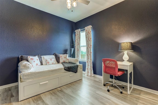 bedroom featuring baseboards, ceiling fan, and wood finished floors
