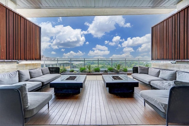 wooden deck with an outdoor living space with a fire pit
