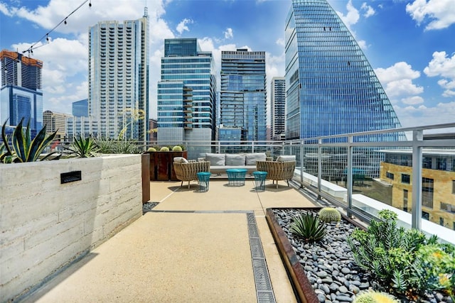 view of patio with a view of city, outdoor lounge area, and a balcony