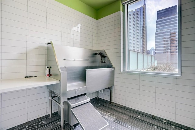 miscellaneous room with tile walls and a city view