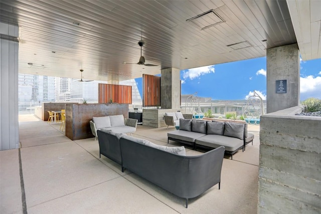 view of patio / terrace with a ceiling fan, outdoor lounge area, and outdoor dry bar