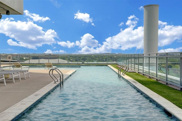 view of swimming pool with fence