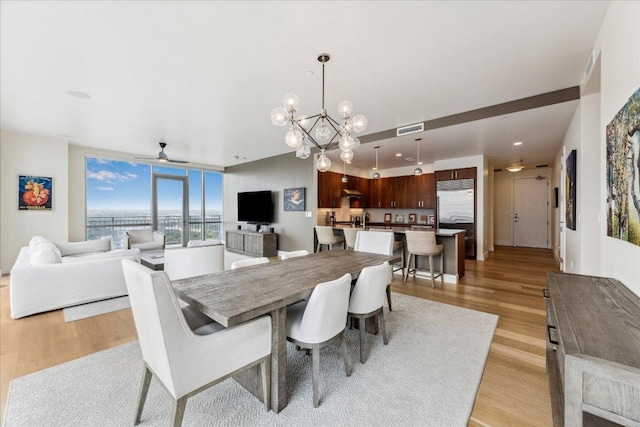 dining space featuring visible vents, recessed lighting, light wood finished floors, and ceiling fan with notable chandelier
