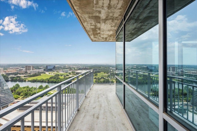 balcony featuring a view of city and a water view