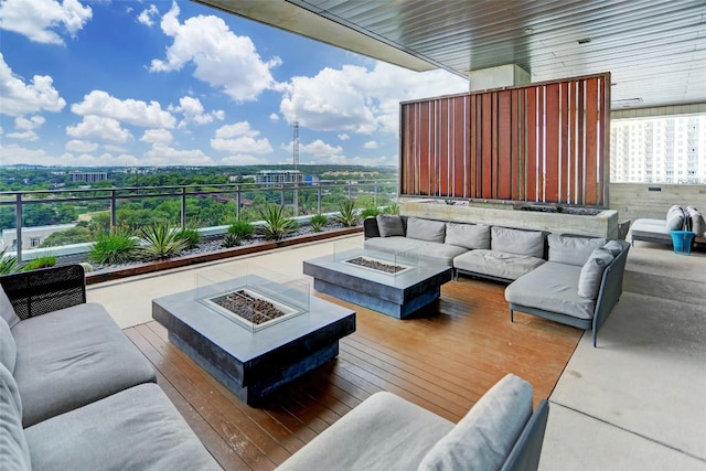 exterior space with an outdoor living space with a fire pit and a wooden deck