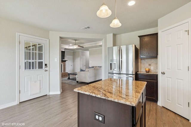 kitchen featuring visible vents, dark brown cabinetry, ceiling fan, stainless steel fridge with ice dispenser, and light wood finished floors