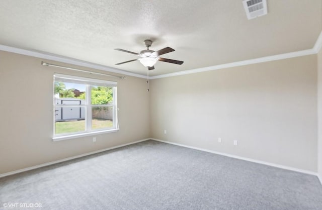 spare room with carpet flooring, ceiling fan, baseboards, visible vents, and ornamental molding