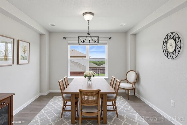 2403 Spirit Dancer Dr, Copperas Cove, TX 76522 - dining room with a chandelier, wood finished floors, and baseboards