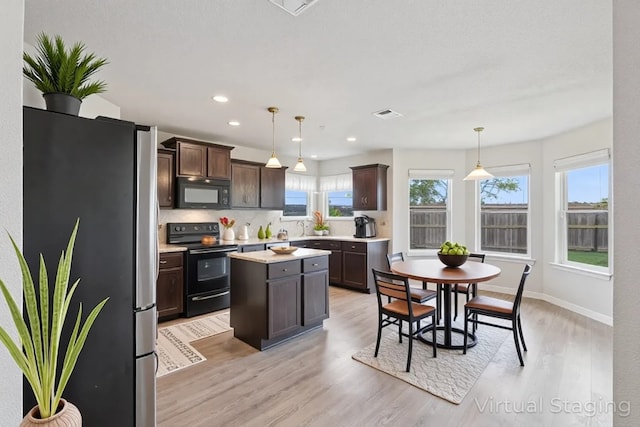 2403 Spirit Dancer Dr, Copperas Cove, TX 76522 - kitchen with black appliances, dark brown cabinets, light wood-type flooring, light countertops, and recessed lighting