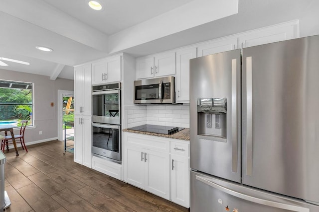 kitchen featuring decorative backsplash, dark wood finished floors, stone counters, stainless steel appliances, and white cabinetry