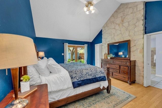 bedroom with high vaulted ceiling, ceiling fan, wood finished floors, and access to exterior