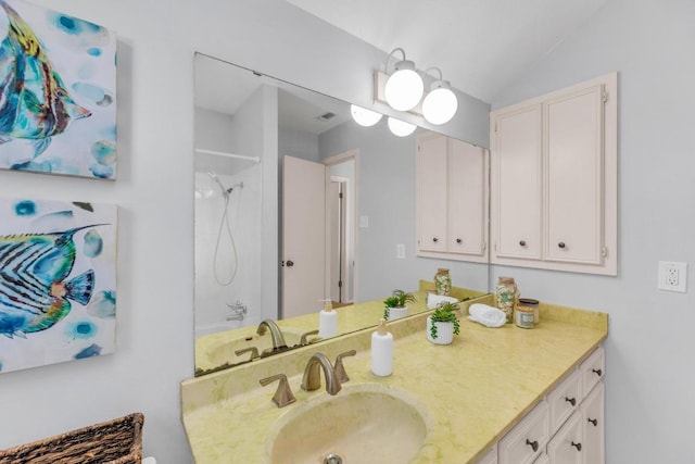 bathroom featuring vanity and vaulted ceiling