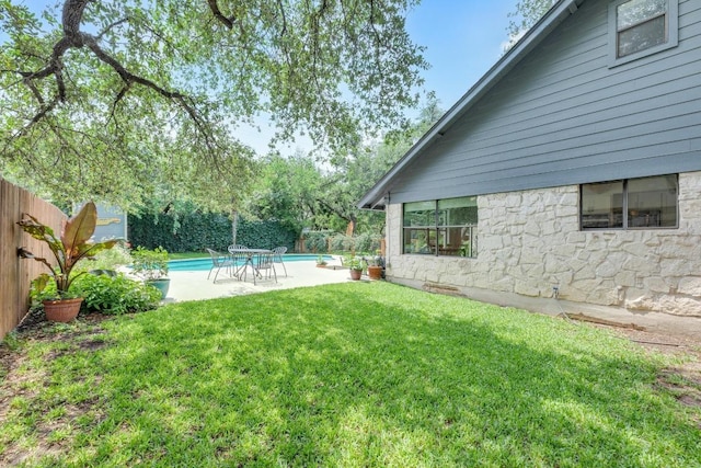 view of yard featuring a patio, a fenced in pool, and a fenced backyard
