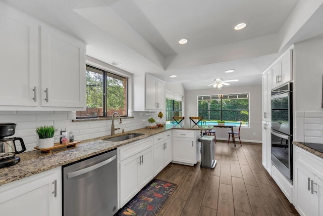 kitchen featuring a sink, white cabinets, and stainless steel appliances