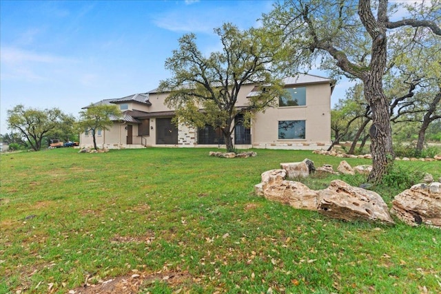 view of front of house featuring a front lawn and stucco siding