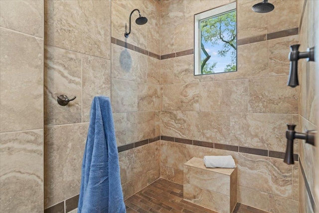 full bath featuring tiled shower
