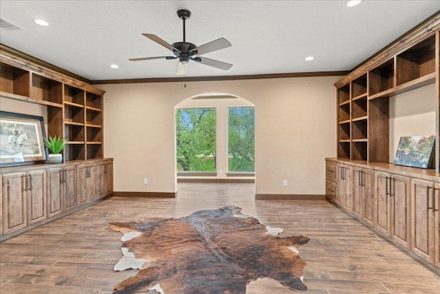 unfurnished living room with crown molding, baseboards, recessed lighting, and wood finished floors