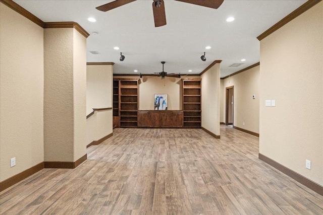 interior space with crown molding, baseboards, and ceiling fan