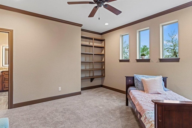 carpeted bedroom featuring baseboards, connected bathroom, and crown molding