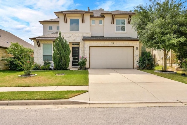 prairie-style home with a front yard, a garage, concrete driveway, stone siding, and stucco siding