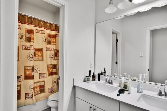 bathroom with double vanity, toilet, curtained shower, and a sink