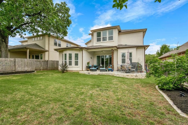 rear view of property featuring a patio, a fenced backyard, stucco siding, and a yard