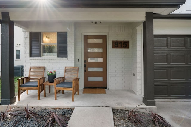 815 Sheraton Ave, Austin, TX 78745 - property entrance with a porch, brick siding, and a garage