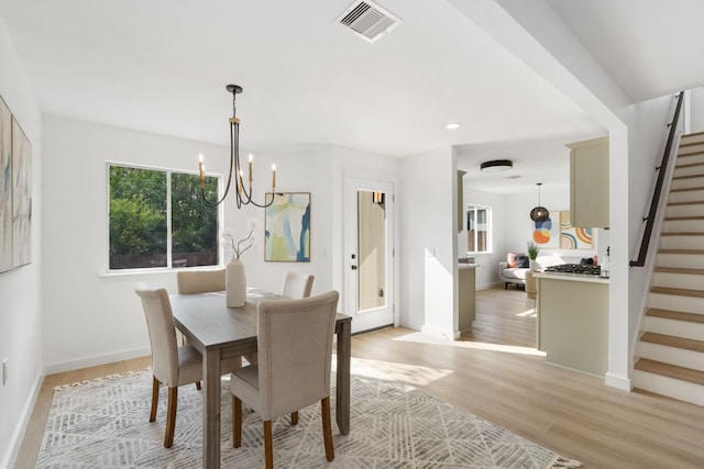 815 Sheraton Ave, Austin, TX 78745 - dining room featuring stairway, a chandelier, light wood finished floors, baseboards, and recessed lighting