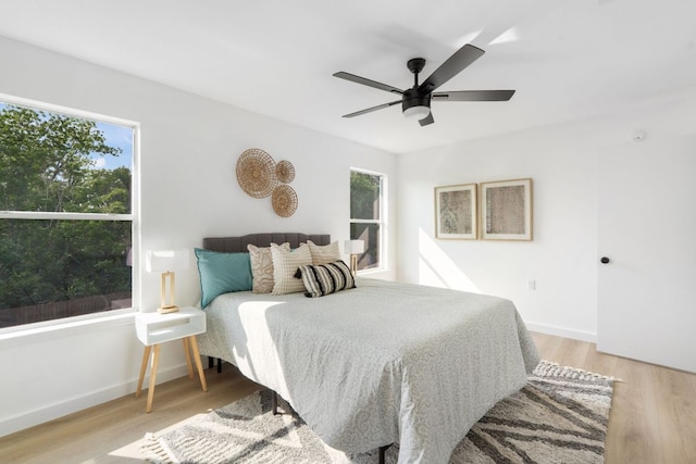 815 Sheraton Ave, Austin, TX 78745 - bedroom with light wood-style floors, baseboards, and a ceiling fan