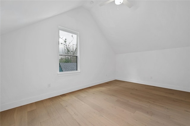 additional living space featuring baseboards, ceiling fan, lofted ceiling, and hardwood / wood-style floors