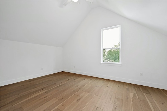 additional living space featuring a ceiling fan, hardwood / wood-style flooring, baseboards, and lofted ceiling