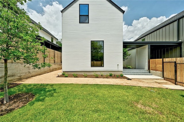 back of property with fence and a yard