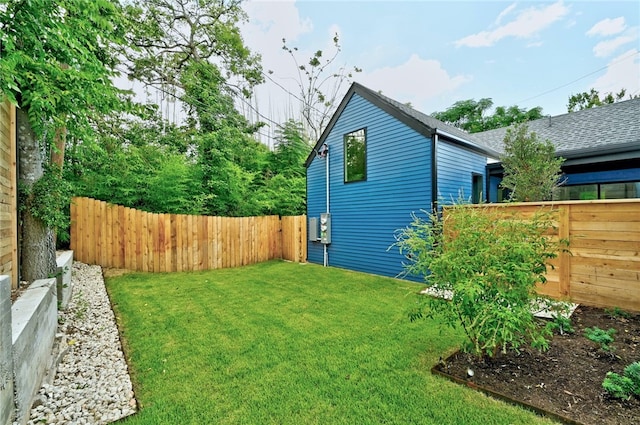 view of property exterior featuring a lawn and a fenced backyard