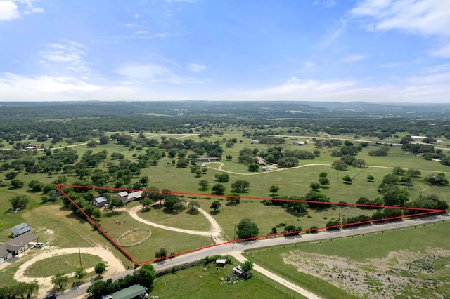 birds eye view of property with a rural view