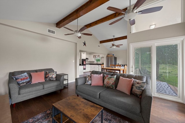 living area with visible vents, ceiling fan, wood finished floors, and beam ceiling