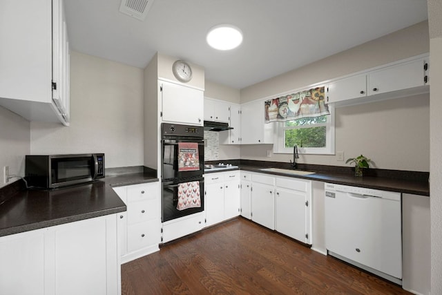 kitchen with dobule oven black, visible vents, white dishwasher, a sink, and stainless steel microwave