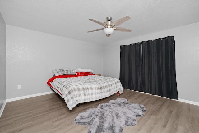 509 Peony Ct, Jarrell, TX 76537 - bedroom with a ceiling fan, baseboards, and wood finished floors